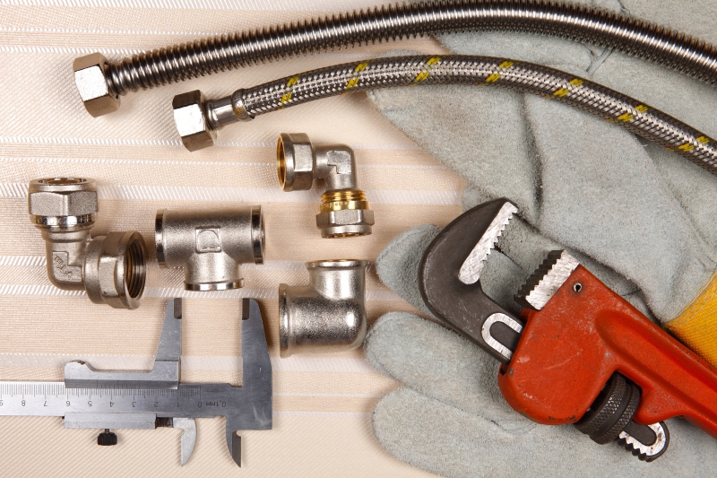 Plumber working on pipes in a South Norwood home
